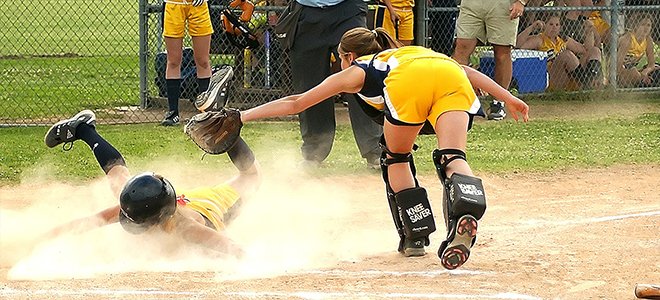 Gilrs playing softball coach